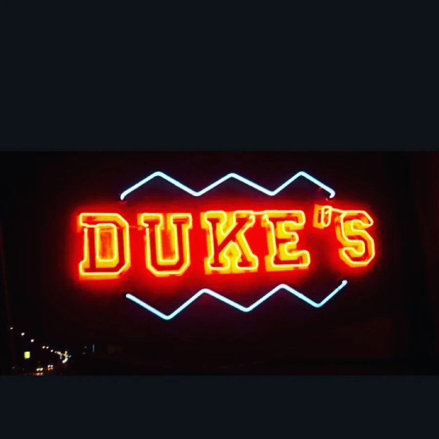 Duke's neon sign glowing